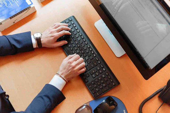 Receptionist typing on computer